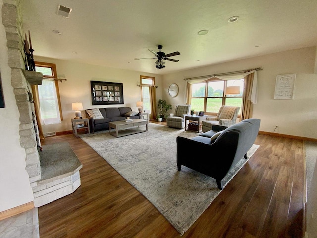 living room featuring ceiling fan and hardwood / wood-style floors