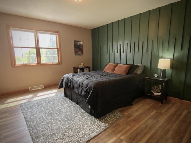 bedroom with hardwood / wood-style flooring