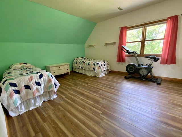 bedroom featuring lofted ceiling and wood-type flooring