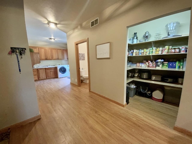 interior space with light hardwood / wood-style floors and washer / clothes dryer