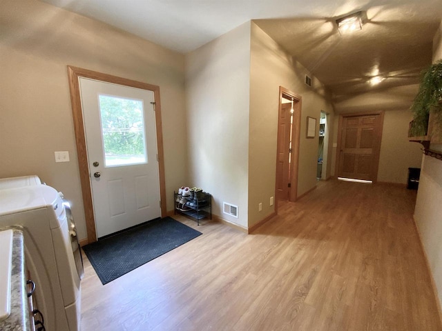 interior space featuring washer and dryer and light hardwood / wood-style flooring