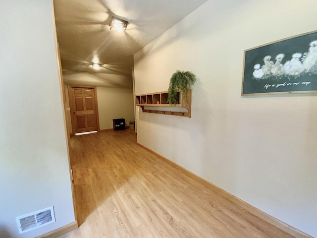 hall with hardwood / wood-style floors