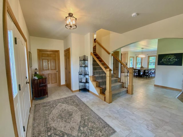 entryway featuring a chandelier