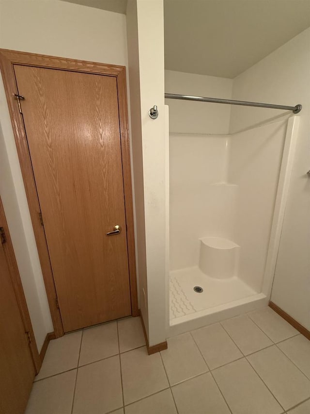 bathroom featuring a shower and tile patterned flooring