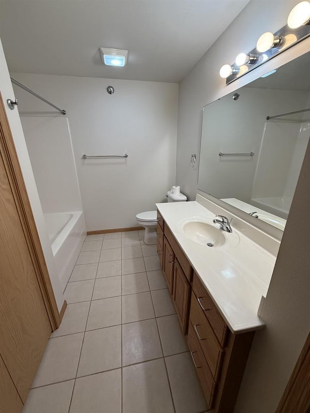 bathroom with toilet, tile patterned floors, and vanity