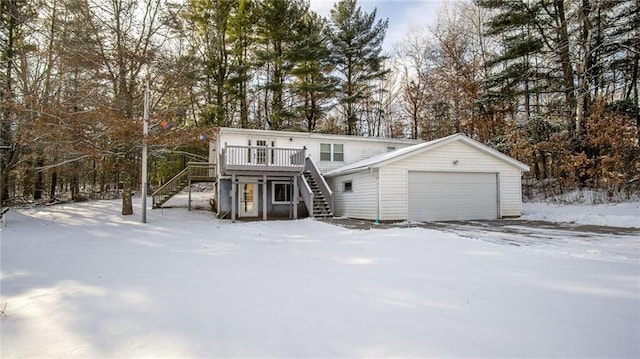 view of property with a wooden deck and a garage