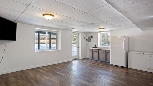 kitchen featuring a paneled ceiling, dark hardwood / wood-style floors, sink, and white fridge