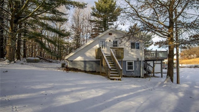 snow covered property with a deck