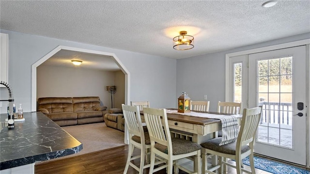 dining space featuring dark hardwood / wood-style floors and a textured ceiling