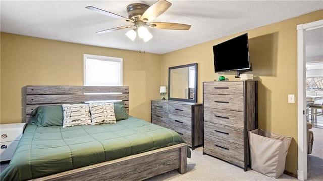 bedroom featuring light carpet and ceiling fan