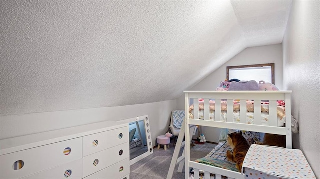 bedroom with a textured ceiling, carpet flooring, and lofted ceiling