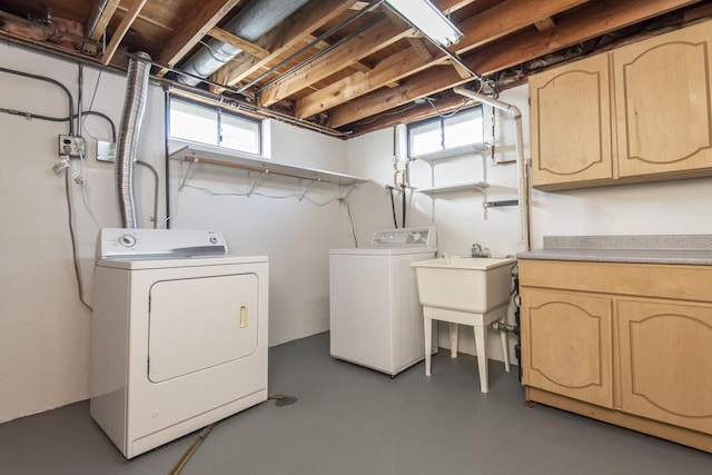 washroom with cabinets and washer and clothes dryer