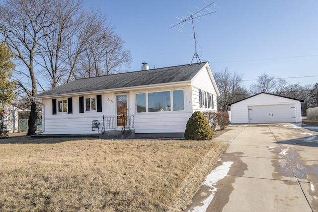 view of front of house featuring a front yard, an outdoor structure, and a garage