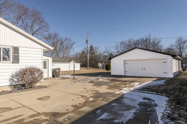 exterior space featuring a garage and an outbuilding