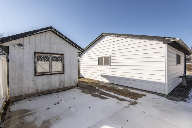 view of property exterior featuring an outbuilding and a patio