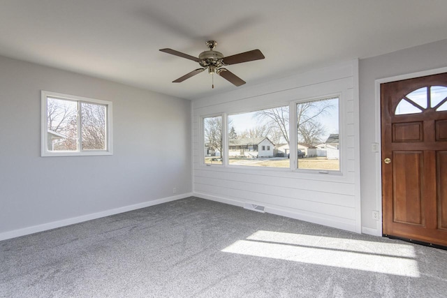 carpeted entrance foyer with ceiling fan