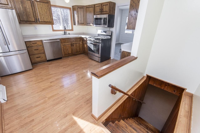 kitchen featuring light wood-type flooring, appliances with stainless steel finishes, and sink