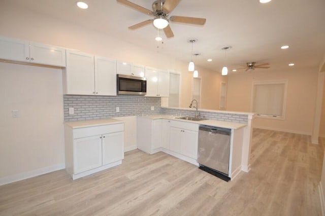 kitchen with white cabinetry, ceiling fan, appliances with stainless steel finishes, hanging light fixtures, and sink