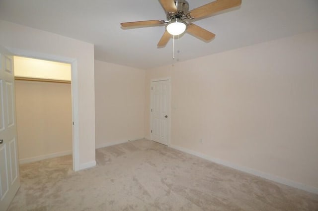 unfurnished bedroom featuring ceiling fan and light carpet