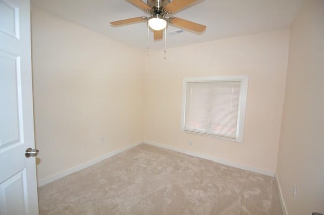 carpeted spare room with ceiling fan