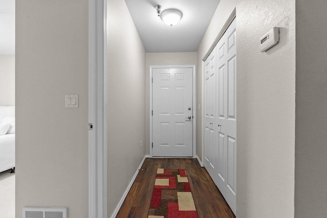 hallway with dark wood-type flooring