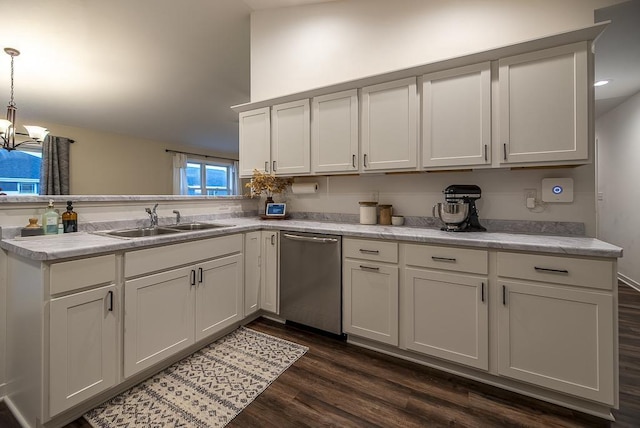 kitchen with pendant lighting, stainless steel dishwasher, sink, white cabinets, and a chandelier