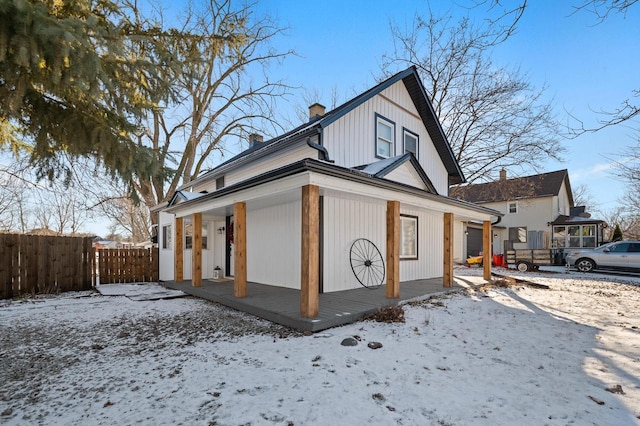 view of snowy exterior featuring a porch