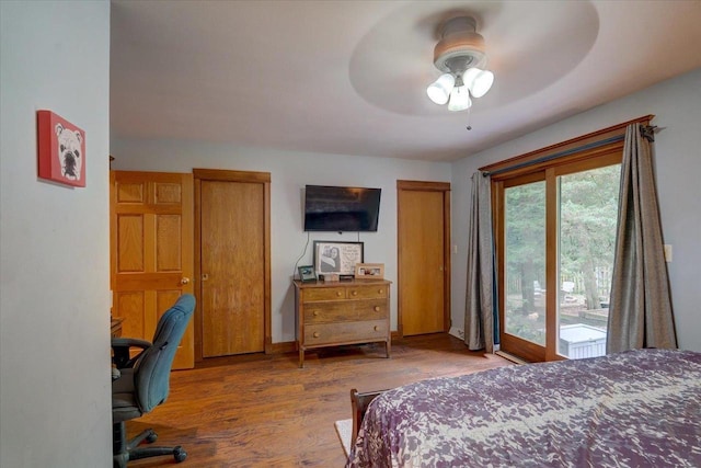 bedroom featuring ceiling fan, access to exterior, and hardwood / wood-style floors