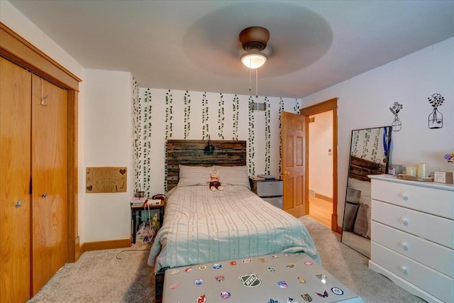 carpeted bedroom featuring a closet and ceiling fan