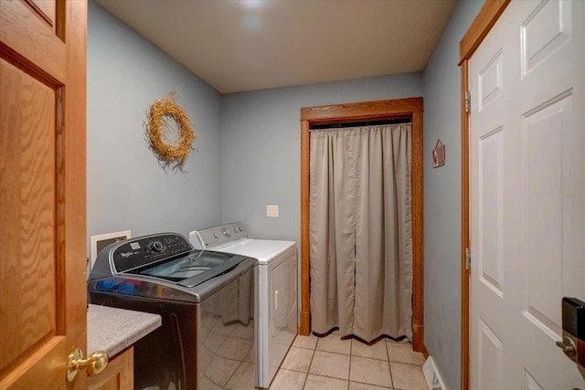 laundry area with light tile patterned floors and independent washer and dryer