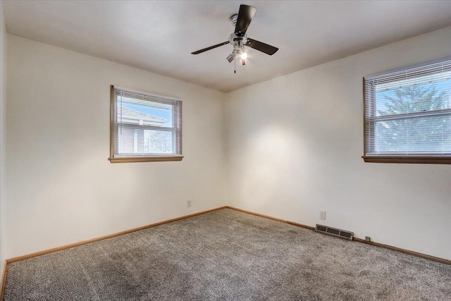 spare room featuring carpet floors and ceiling fan