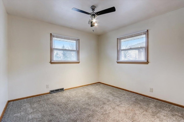 spare room with ceiling fan, carpet flooring, and a healthy amount of sunlight