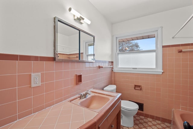 full bathroom with toilet, tile walls, tub / shower combination, and vanity