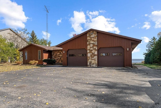 view of front facade with a garage and a water view