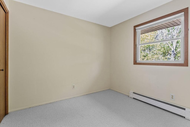 carpeted spare room with baseboard heating