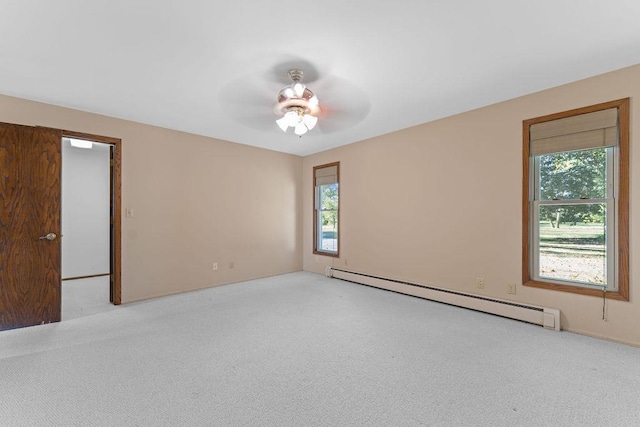 carpeted empty room featuring baseboard heating and ceiling fan