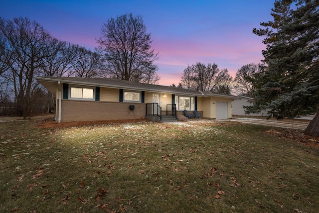 single story home with a yard and a garage