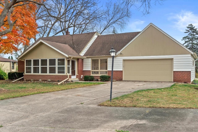 ranch-style home with a front lawn and a garage