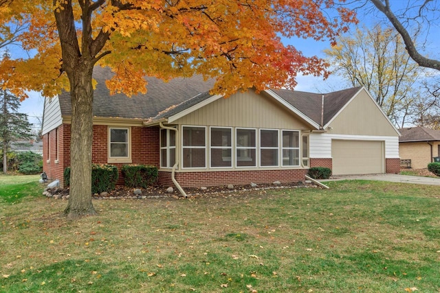 ranch-style home with a front yard, a sunroom, and a garage