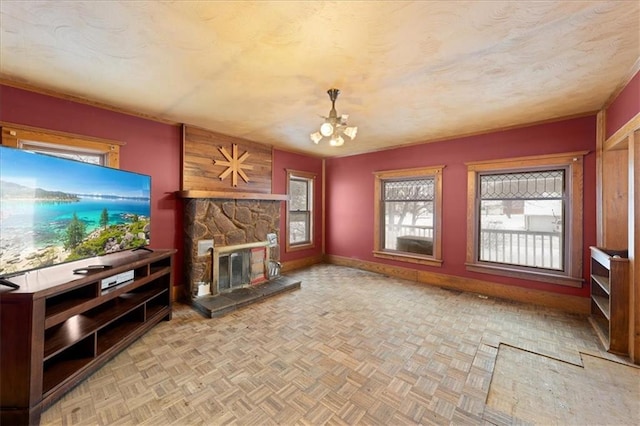 unfurnished living room featuring light parquet floors, plenty of natural light, and a fireplace