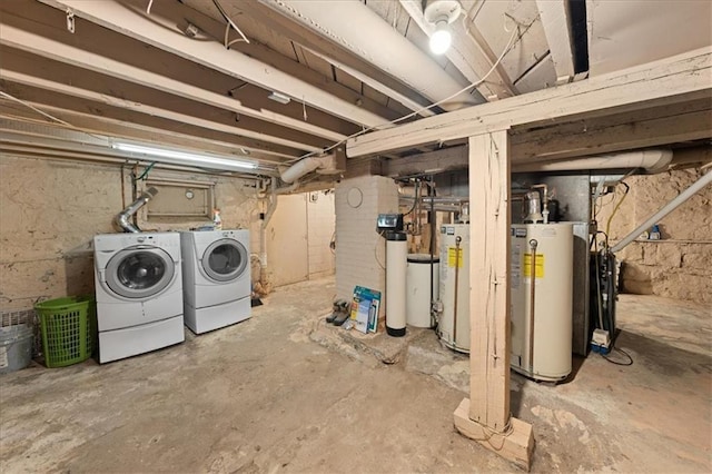 basement featuring washer and clothes dryer and water heater