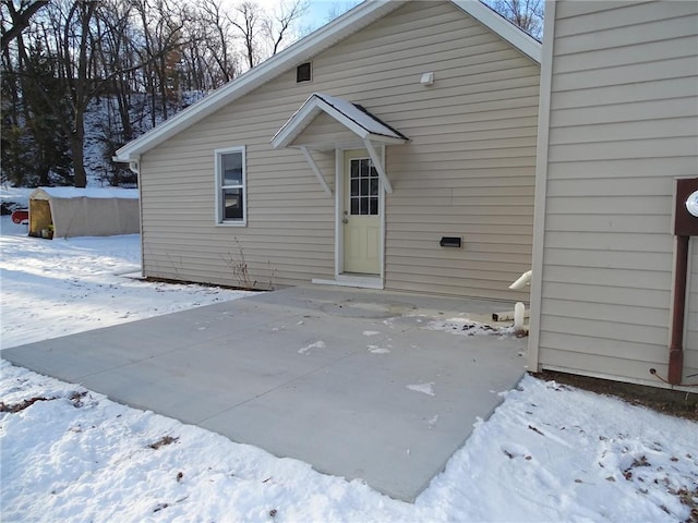 view of snow covered back of property