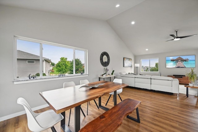 dining area featuring hardwood / wood-style flooring, high vaulted ceiling, and ceiling fan