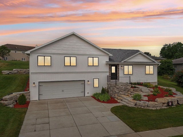 view of front of home featuring a garage and a yard