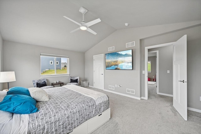 carpeted bedroom with ceiling fan and lofted ceiling