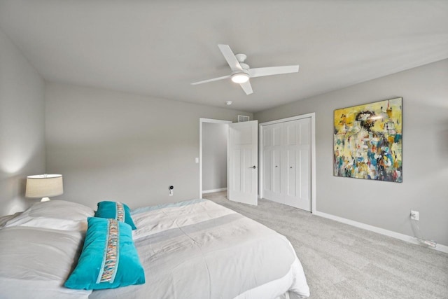 carpeted bedroom with ceiling fan and a closet