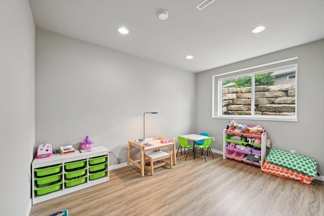 playroom with light hardwood / wood-style floors