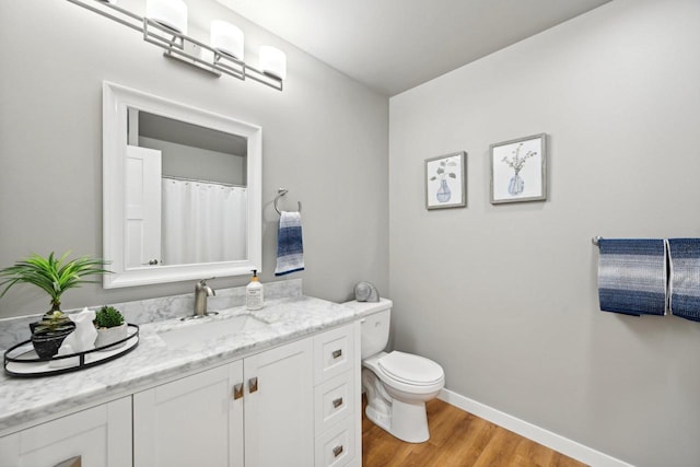 bathroom featuring hardwood / wood-style floors, toilet, and vanity