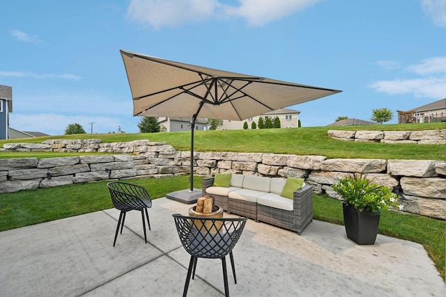 view of patio with an outdoor living space with a fire pit