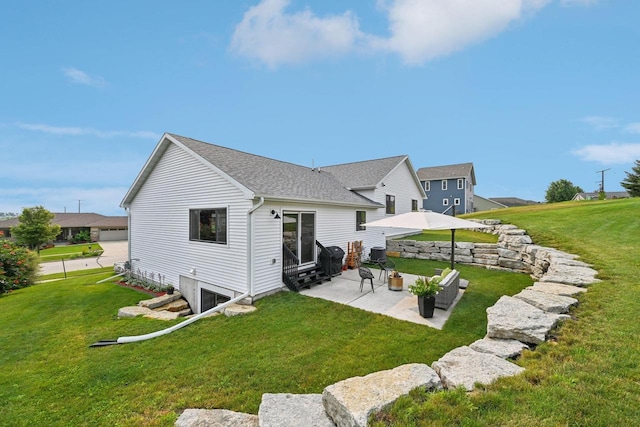 rear view of property featuring a yard and a patio